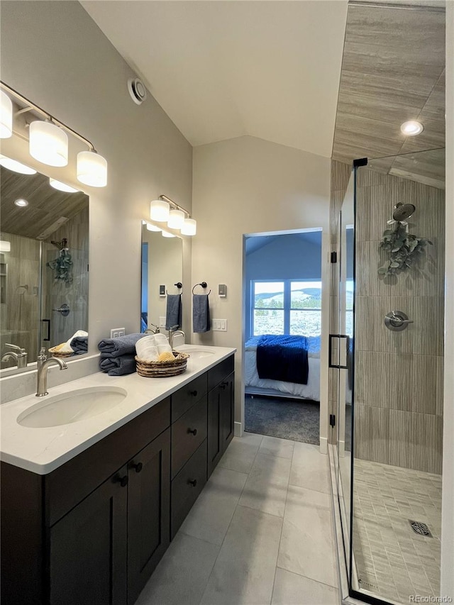 bathroom featuring a shower with shower door, vanity, and vaulted ceiling