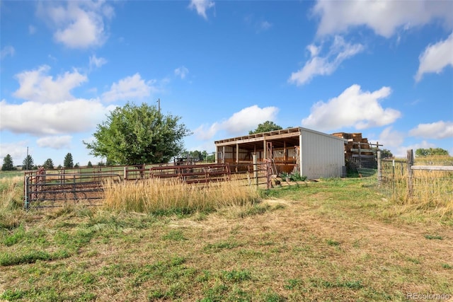 view of yard featuring a rural view and an outdoor structure