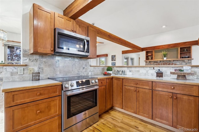 kitchen featuring stainless steel appliances, tasteful backsplash, light hardwood / wood-style flooring, and beam ceiling