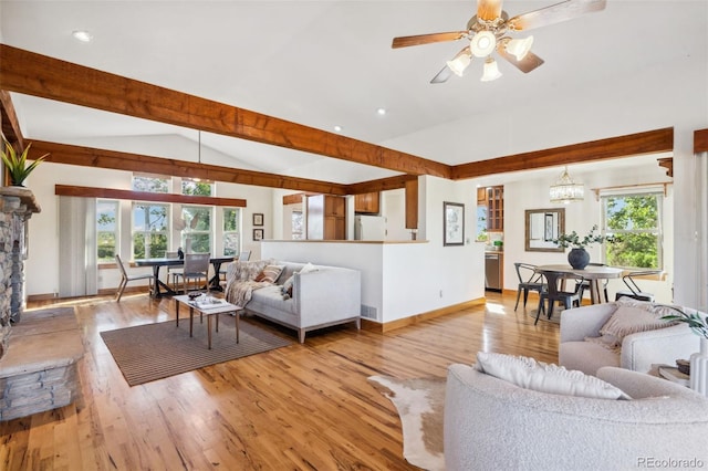 living room featuring light hardwood / wood-style flooring, plenty of natural light, ceiling fan with notable chandelier, and vaulted ceiling with beams