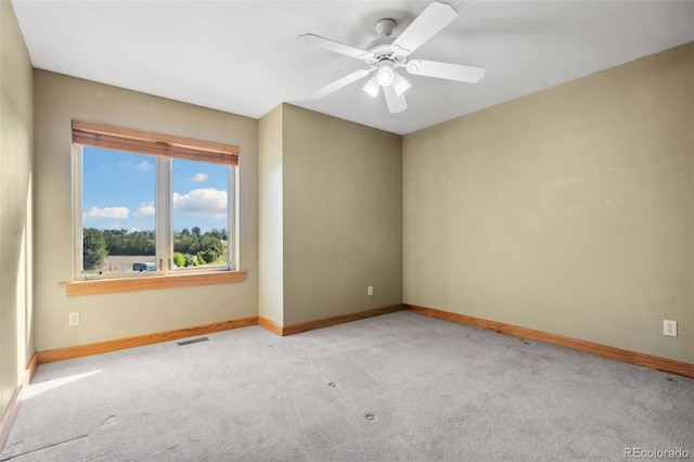 empty room with light colored carpet and ceiling fan