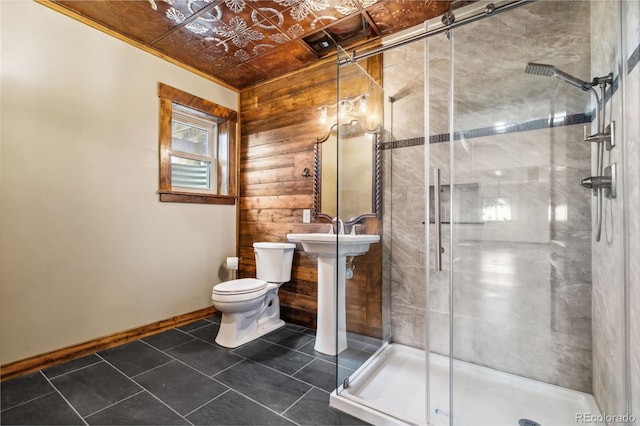 bathroom featuring tile patterned flooring, walk in shower, wooden walls, and toilet