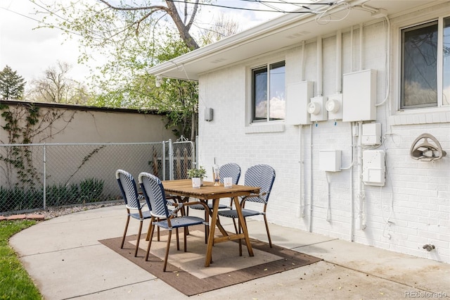 view of patio featuring fence and outdoor dining area