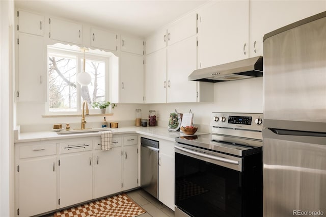 kitchen featuring under cabinet range hood, stainless steel appliances, white cabinets, and a sink