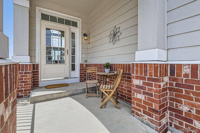 entrance to property featuring covered porch