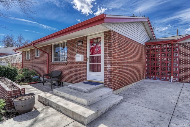 exterior space with a patio and brick siding