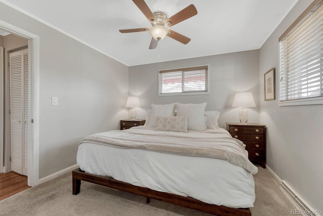 bedroom featuring crown molding, light colored carpet, ceiling fan, and baseboards