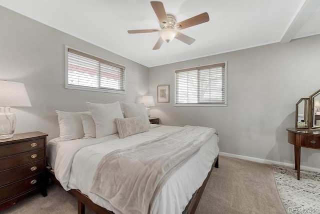 bedroom with light carpet, ceiling fan, multiple windows, and baseboards