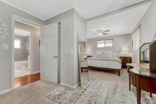 bedroom featuring baseboards, crown molding, and light colored carpet