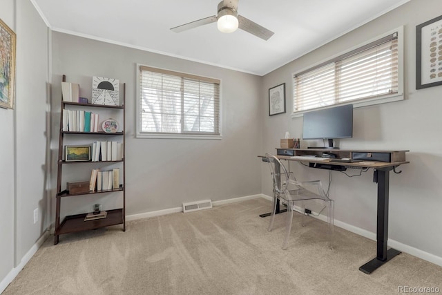 office area with light carpet, plenty of natural light, visible vents, and baseboards