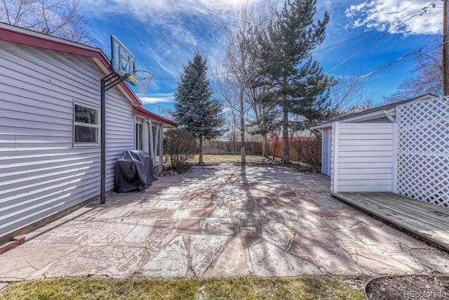 view of patio / terrace featuring an outdoor structure, fence, and area for grilling