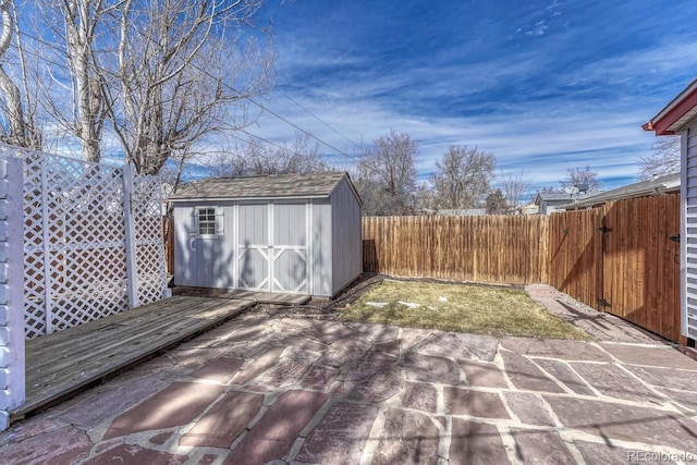 exterior space featuring an outbuilding, a storage unit, a patio area, and a fenced backyard