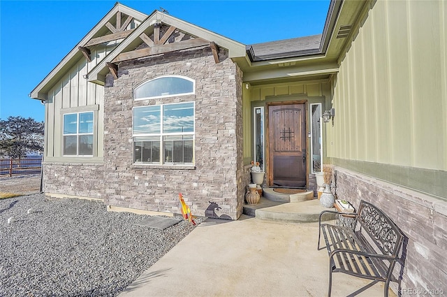 view of exterior entry featuring a patio