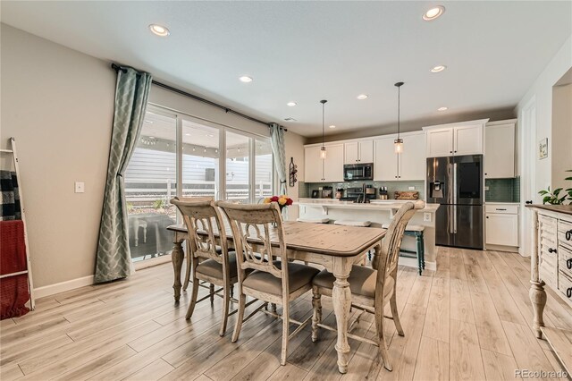 dining area with light wood-type flooring