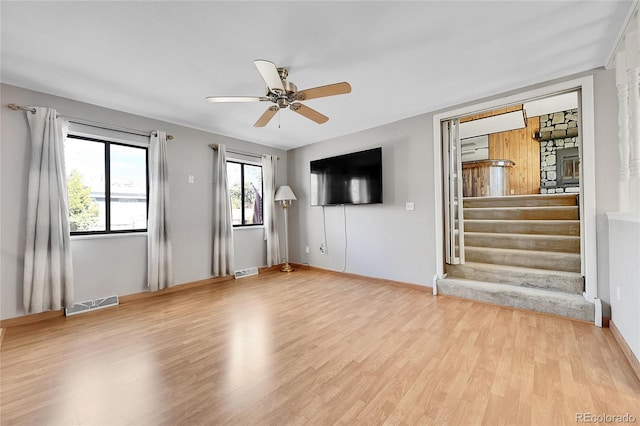 unfurnished living room featuring ceiling fan and light wood-type flooring