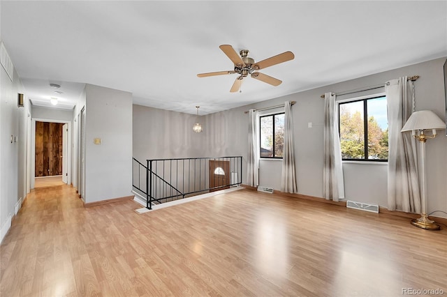 spare room with ceiling fan and light hardwood / wood-style flooring