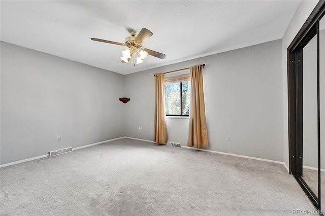 unfurnished bedroom with light colored carpet and ceiling fan