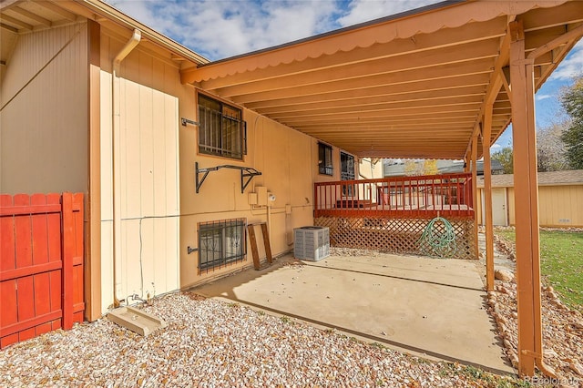 view of patio with central air condition unit and a wooden deck