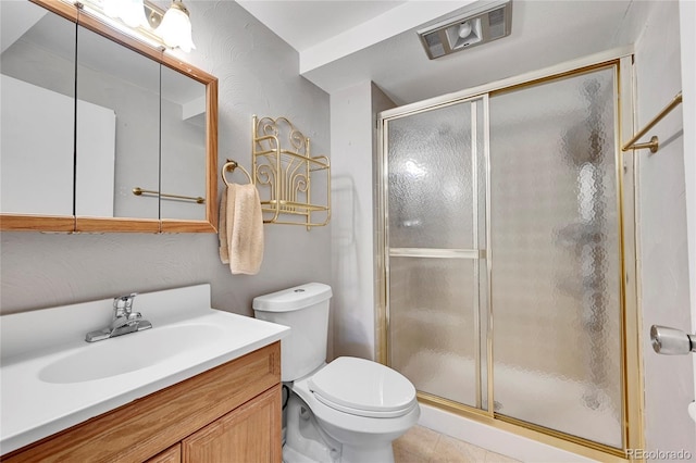 bathroom featuring vanity, toilet, and walk in shower