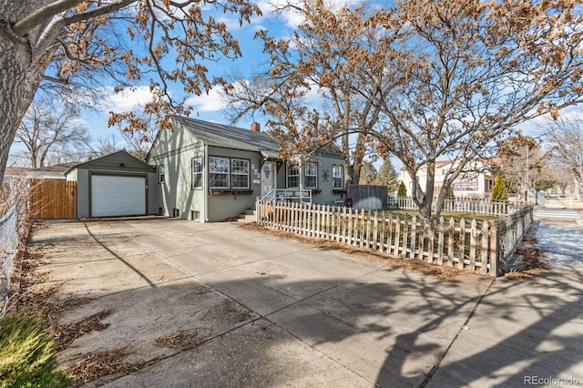 ranch-style house with a garage and an outbuilding