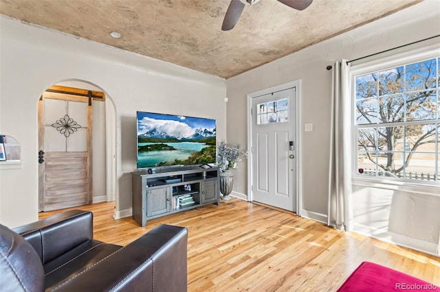 living room featuring hardwood / wood-style flooring and ceiling fan