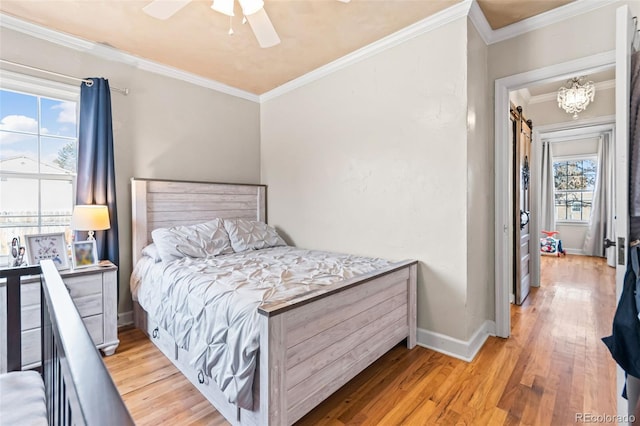 bedroom featuring crown molding, light hardwood / wood-style floors, and ceiling fan