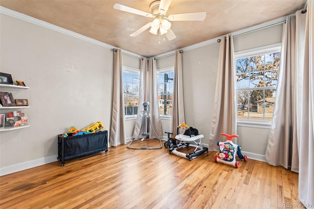 misc room with crown molding, ceiling fan, and light hardwood / wood-style flooring