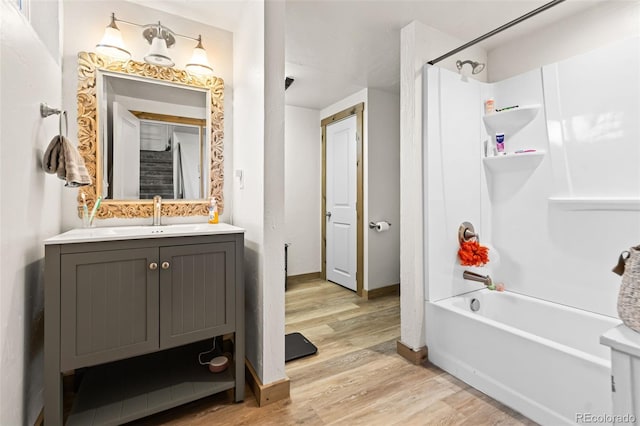 bathroom featuring shower / bath combination, wood-type flooring, and vanity