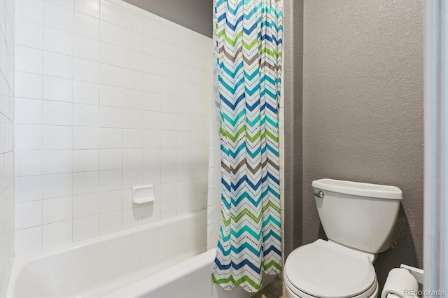 bathroom with shower / bath combo and toilet