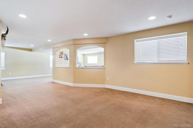 carpeted empty room with plenty of natural light