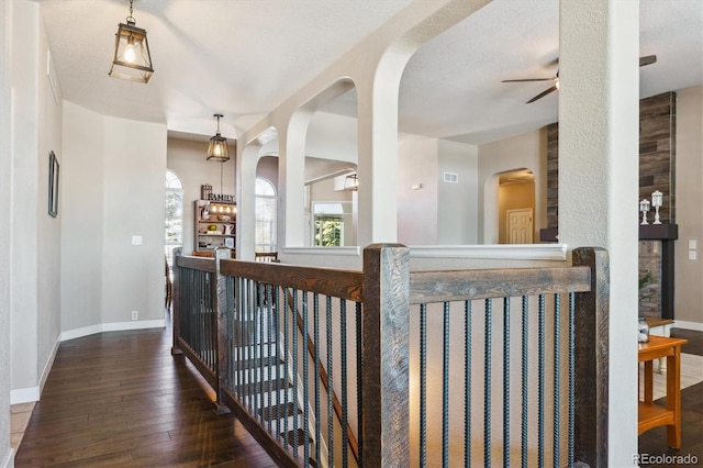 hallway featuring a textured ceiling and dark hardwood / wood-style floors