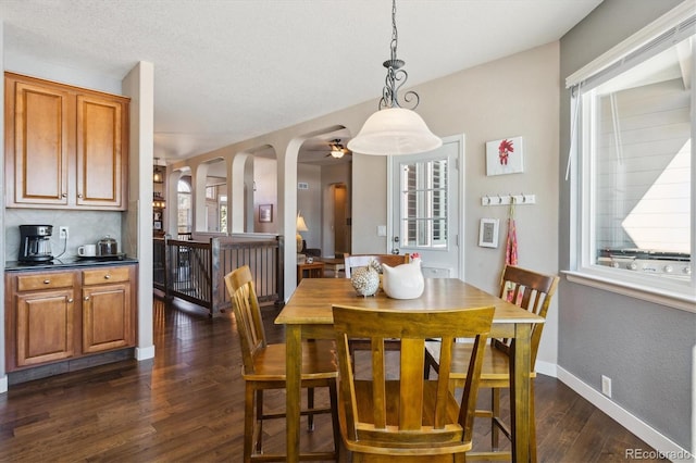 dining space featuring dark wood-type flooring and a healthy amount of sunlight