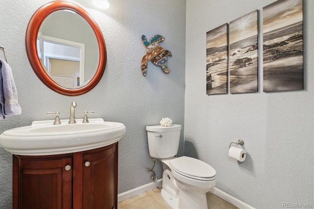 bathroom with tile patterned floors, vanity, and toilet