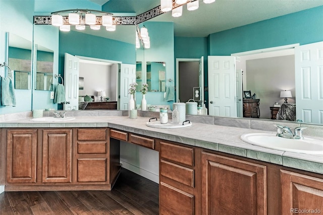 bathroom with vanity, wood-type flooring, and a shower with door