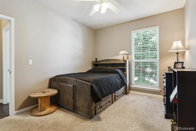 bedroom featuring ceiling fan and light carpet