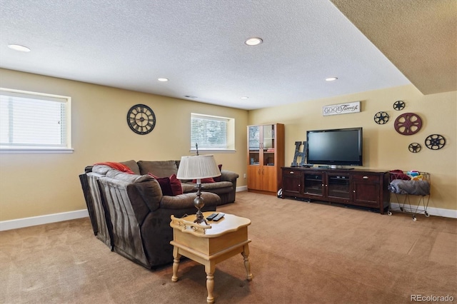 carpeted living room featuring a textured ceiling