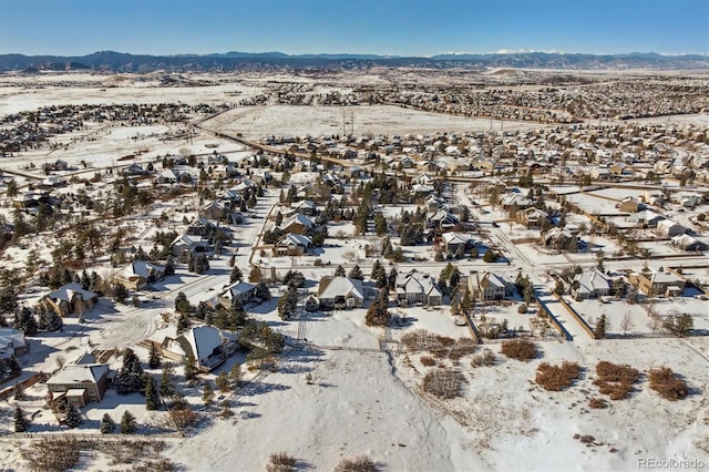 snowy aerial view featuring a mountain view