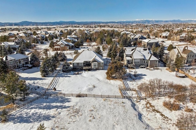 snowy aerial view featuring a mountain view