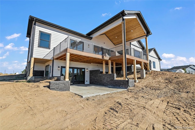 rear view of property with a patio and a wooden deck