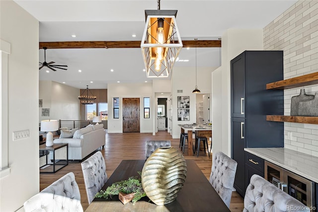 living room featuring beam ceiling, a brick fireplace, ceiling fan, and dark wood-type flooring