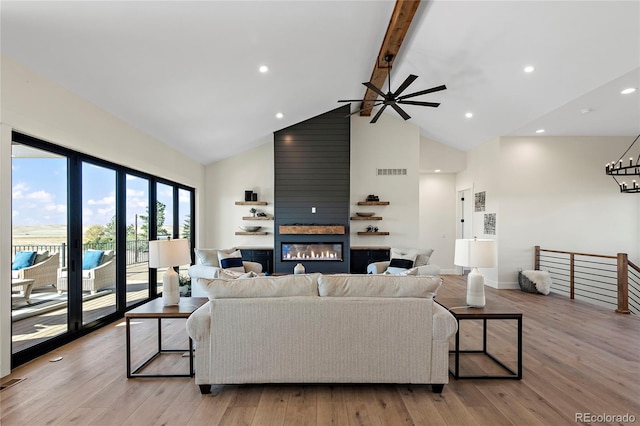 living room with beam ceiling, ceiling fan, light hardwood / wood-style flooring, and high vaulted ceiling