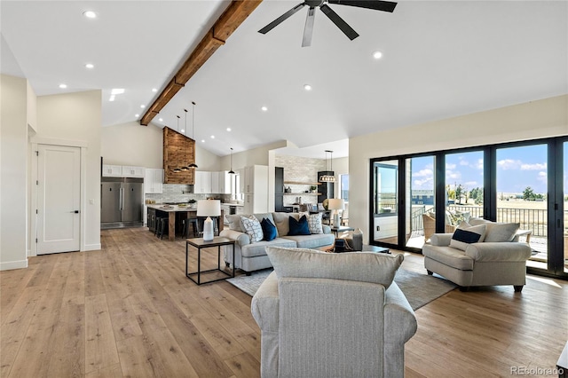 living room featuring beam ceiling, high vaulted ceiling, light hardwood / wood-style flooring, and ceiling fan