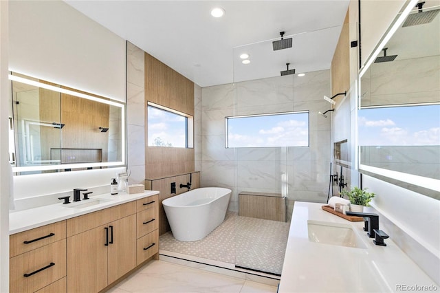 bathroom featuring vanity, plus walk in shower, and tile walls