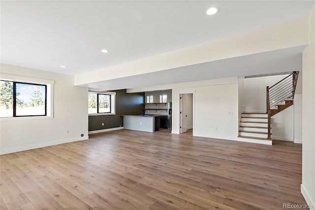 unfurnished living room with hardwood / wood-style flooring