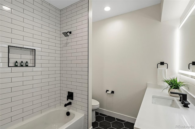 full bathroom with tile patterned flooring, vanity, tiled shower / bath combo, and toilet