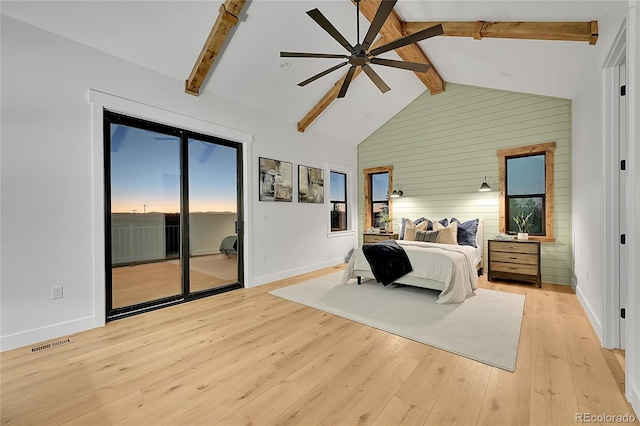 bedroom with access to exterior, light wood-type flooring, multiple windows, and beamed ceiling