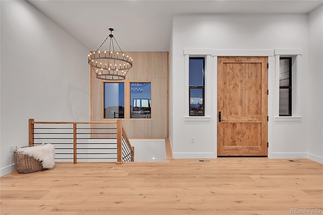 foyer with a chandelier and hardwood / wood-style flooring