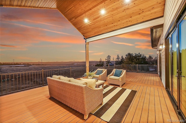 deck at dusk with outdoor lounge area