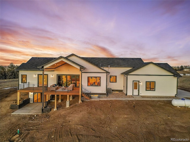 view of front of home featuring a patio and a wooden deck