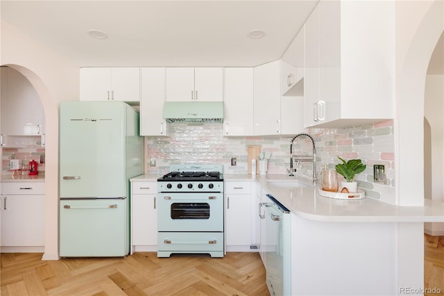 1010 N Jasmine St, Denver, CO 80220 - kitchen featuring white appliances, ventilation hood, arched walkways, white cabinetry, and light countertops